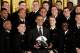 WASHINGTON, DC - APRIL 12: U.S. President Barack Obama poses with the Navy football team after he presented the Commander-in-Chief Trophy to the United States Naval Academy football team during a ceremony at the White House April 12, 2013 in Washington,