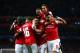 LONDON, ENGLAND - OCTOBER 01: Mesut Oezil (C)of Arsenal is congratulated by teammates after scoring the opening goal during UEFA Champions League Group F match between Arsenal FC and SSC Napoli at Emirates Stadium on October 1, 2013 in London, England.