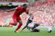 LIVERPOOL, ENGLAND - SEPTEMBER 21: Raheem Sterling of Liverpool in action with Nathaniel Clyne of Southampton during the Barclays Premier League match between Liverpool and Southampton at Anfield on September 21, 2013 in Liverpool, England. (Photo by Cl