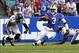 Sep 29, 2013; Orchard Park, NY, USA; Buffalo Bills quarterback EJ Manuel (3) slides as Baltimore Ravens cornerback Corey Graham (24) looks to make a tackle during the second half at Ralph Wilson Stadium. Bills beat Ravens 23 to 20. Mandatory Credit: Timo