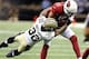 Sep 22, 2013; New Orleans, LA, USA; New Orleans Saints strong safety Kenny Vaccaro (32) tackles Arizona Cardinals wide receiver Michael Floyd (15) in the fourth quarter of their game at Mercedes-Benz Superdome. Mandatory Credit: Chuck Cook-USA TODAY Sport