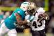 NEW ORLEANS, LA - SEPTEMBER 30: Don Jones #36 of the Miami Dolphins tackles Darren Sproles #43 of the New Orleans Saints during a game at the Mercedes-Benz Superdome on September 30, 2013 in New Orleans, Louisiana. (Photo by Stacy Revere/Getty Images)