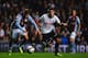 BIRMINGHAM, ENGLAND - SEPTEMBER 24: Erik Lamela of Tottenham Hotspur battles with Joe Bennett of Aston Villa during the Capital One Cup third round match between Aston Villa and Tottenham Hotspur at Villa Park on September 24, 2013 in Birmingham, England.