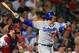Oct 3, 2013; Atlanta, GA, USA; Los Angeles Dodgers first baseman Adrian Gonzalez (23) hits a 2-run home run against the Atlanta Braves during the third inning of game one of the National League divisional series playoff baseball game at Turner Field. Mand