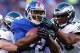 EAST RUTHERFORD, NJ - DECEMBER 30: David Wilson #22 of the New York Giants carries the ball as DeMeco Ryans #59 and Kurt Coleman #42 of the Philadelphia Eagles tackle at MetLife Stadium on December 30, 2012 in East Rutherford, New Jersey. The New York
