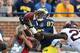 ANN ARBOR, MI - OCTOBER 05: Devin Funchess #87 of the Michigan Wolverines makes the catch for a 46 yard gain over Jeremy Baltzar #22 of the Minnesota Golden Gophers during the fourth quarter of the game at Michigan Stadium on October 5, 2013 in Ann Arbor,
