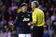 SUNDERLAND, ENGLAND - OCTOBER 05: Referee Chris Foy talks to Wayne Rooney of Manchester United during the Barclays Premier League match between Sunderland and Manchester United at the Stadium of Light on October 5, 2013 in Sunderland, England. (Photo by