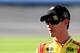 KANSAS CITY, KS - OCTOBER 04: Joey Logano, driver of the #22 Shell-Pennzoil Ford, stands on the grid during qualifying for the NASCAR Sprint Cup Series 13th Annual Hollywood Casino 400 at Kansas Speedway on October 4, 2013 in Kansas City, Kansas. (Photo