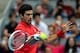 BEIJING, CHINA - OCTOBER 06: Novak Djokovic of Serbia returns a shot against Rafael Nadal of Spain during the Men's Single Final on night day of the China Open at the China National Tennis Center on October 6, 2013 in Beijing, China. (Photo by Feng Li/