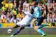 NORWICH, ENGLAND - OCTOBER 06: Demba Ba of Chelsea tries to go round John Ruddy of Norwich City during the Barclays Premier League match between Norwich City and Chelsea at Carrow Road on October 6, 2013 in Norwich, England. (Photo by Julian Finney/Gett