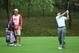 DUBLIN, OH - OCTOBER 06: Jordan Spieth of the U.S. Team hits his approach shot on the second hole as his caddie Michael Greller looks on during the Day Four Singles Matches at the Muirfield Village Golf Club on October 6, 2013 in Dublin, Ohio. (Photo