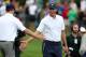 Oct 6, 2013; Dublin, OH, USA; Matt Kuchar celebrates with Zach Johnson after their matches during the fourth round of the Presidents Cup at Muirfield Village Golf Club. Mandatory Credit: Brian Spurlock-USA TODAY Sports