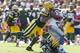 GREEN BAY, WI - OCTOBER 6: M.D. Jennings #43 and Mike Neal #96 of the Green Bay Packers team up to bring down Reggie Bush #21 of the Detroit Lions at Lambeau Field on October 6, 2013 in Green Bay, Wisconsin. The Packers defeated the Lions 22-9. (Photo