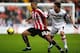 SHEFFIELD, UNITED KINGDOM - JANUARY 24: Kyle Naughton of Sheffield United battles for the ball with Matt Holland of Charlton Athletic during the FA Cup Sponsored by E.on 4th Round match between Sheffield United and Charlton Athletic at Bramall Lane on Ja