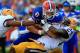 GAINESVILLE, FL - OCTOBER 06: Tharold Simon #24 of the LSU Tigers tackles Jeff Driskel #6 of the Florida Gators during the game at Ben Hill Griffin Stadium on October 6, 2012 in Gainesville, Florida. (Photo by Sam Greenwood/Getty Images)
