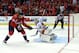 WASHINGTON, DC - OCTOBER 03: Mikhail Grabovski #84 of the Washington Capitals gets the puck past Karri Ramo #31 of the Calgary Flames for a shootout goal during the Washington Capitals home opener at Verizon Center on October 3, 2013 in Washington, DC.