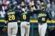 Oct 7, 2013; Detroit, MI, USA; Oakland Athletics second baseman Eric Sogard (28) , shortstop Jed Lowrie (8) and right fielder Josh Reddick (16) celebrate after game three of the American League divisional series playoff baseball game against the Detroit T