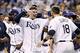 Oct 7, 2013; St. Petersburg, FL, USA; Tampa Bay Rays catcher Jose Lobaton (middle) is congratulated by teammates including Ben Zobrist (18) at home plate after he hit a walk off home run during the ninth inning against the Boston Red Sox in game three of