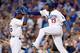 LOS ANGELES, CA - OCTOBER 06: Hanley Ramirez #13 of the Los Angeles Dodgers celebrates with Yasiel Puig #66 as Ramirez scores a run in the third inning against the Atlanta Braves during Game Three of the National League Division Series at Dodger Stadium