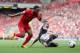 LIVERPOOL, ENGLAND - SEPTEMBER 21: Raheem Sterling of Liverpool in action with Nathaniel Clyne of Southampton during the Barclays Premier League match between Liverpool and Southampton at Anfield on September 21, 2013 in Liverpool, England. (Photo by Cl