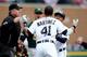 DETROIT, MI - OCTOBER 07: Victor Martinez #41 of the Detroit Tigers is held back while exchanging words with Grant Balfour #50 of the Oakland Athletics in the ninth inning of Game Three of the American League Division Series at Comerica Park on October 7