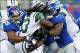 Aug 24, 2013; East Rutherford, NJ, USA; New York Jets running back Chris Ivory (33) is brought down by New York Giants defensive tackle Cullen Jenkins (99) and New York Giants safety Stevie Brown (27) during the first quarter of a preseason game at MetLif
