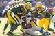 GREEN BAY, WI - OCTOBER 6: Mike Daniels #75, Brad Jones #59 and Nick Perry #53 of the Green Bay Packers make a tackle on Reggie Bush #21 of the Detroit Lions at Lambeau Field on October 6, 2013 in Green Bay, Wisconsin. (Photo Tom Lynn /Getty Images)