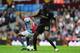 BIRMINGHAM, ENGLAND - SEPTEMBER 28: Manchester City player Yaya Toure (r) holds off Villa player Leandro Bacuna during the Barclays Premier League match between Aston Villa and Manchester City at Villa Park on September 28, 2013 in Birmingham, England.