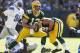 GREEN BAY, WI - OCTOBER 6: Aaron Rodgers #12 of the Green Bay Packers scrambles for a first down against the Detroit Lions defense at Lambeau Field on October 6, 2013 in Green Bay, Wisconsin. The Packers defeated the Lions 22-9. (Photo Tom Lynn /Getty