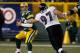 GREEN BAY, WI - DECEMBER 07: Aaron Rodgers #12 of the Green Bay Packers tries to escape from Kelly Gregg #97 of the Baltimore Ravens at Lambeau Field on December 7, 2009 in Green Bay, Wisconsin. The Packers defeated the Ravens 27-17. (Photo by Jonathan Da