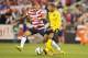 COLUMBUS, OH - SEPTEMBER 11: Danny Williams #14 of the U.S. National Team defends against Ryan Johnson #9 of the Jamaican National Team on September 11, 2012 at Crew Stadium in Columbus, Ohio. (Photo by Jamie Sabau/Getty Images)