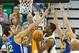 Oct 8, 2013; Salt Lake City, UT, USA; Utah Jazz point guard Alec Burks (10) goes up for a shot between Golden State Warriors center Andrew Bogut (12) and shooting guard Klay Thompson (11) during the first half at EnergySolutions Arena. Mandatory Credit: R