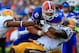GAINESVILLE, FL - OCTOBER 06: Tharold Simon #24 of the LSU Tigers tackles Jeff Driskel #6 of the Florida Gators during the game at Ben Hill Griffin Stadium on October 6, 2012 in Gainesville, Florida. (Photo by Sam Greenwood/Getty Images)