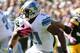 GREEN BAY, WI - OCTOBER 06: Reggie Bush #21 of the Detroit Lions cuts back after a handoff during the game againt the Green Bay Packers at Lambeau Field on October 6, 2013 in Green Bay, Wisconsin. (Photo by Harry How/Getty Images)