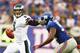EAST RUTHERFORD, NJ - OCTOBER 06: Nick Foles #9 of the Philadelphia Eagles eludes Mathias Kiwanuka #94 of the New York Giants during their game at MetLife Stadium on October 6, 2013 in East Rutherford, New Jersey. (Photo by Al Bello/Getty Images)