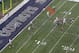 The Cowboys crowd Thomas with three defenders.
