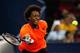 SHANGHAI, CHINA - OCTOBER 10: Gael Monfils of France returns a shot to Roger Federer of Switzerland during day four of the Shanghai Rolex Masters at the Qi Zhong Tennis Center on October 10, 2013 in Shanghai, China. (Photo by Lintao Zhang/Getty Images)