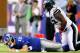EAST RUTHERFORD, NJ - OCTOBER 06: Eli Manning #10 of the New York Giants is tackled by Vinny Curry #75 of the Philadelphia Eagles at MetLife Stadium on October 6, 2013 in East Rutherford, New Jersey. (Photo by Elsa/Getty Images)