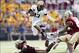 Oct 5, 2013; Boston, MA, USA; Army Black Knights quarterback Kelvin White (13) jumps over Boston College Eagles line backer Steven Daniels (52) during the third quarter at Alumni Stadium. Mandatory Credit: Greg M. Cooper-USA TODAY Sports