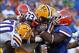 October 6, 2012; Gainesville FL, USA; LSU running back Jeremy Hill (33) runs with the ball as Florida Gators linebacker Jon Bostic (1) during the second half at Ben Hill Griffin Stadium. Florida Gators defeated the Louisiana State 14-6. Mandatory Credit: