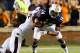 AUBURN, AL - SEPTEMBER 14: Nick Marshall #14 of the Auburn Tigers is tackled by Deontae Skinner #11 of the Mississippi State Bulldogs at Jordan-Hare Stadium on September 14, 2013 in Auburn, Alabama. (Photo by Kevin C. Cox/Getty Images)