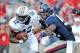 October 13, 2012; Oxford, MS, USA; Auburn Tigers quarterback Jonathan Wallace (12) gets away from Mississippi Rebels defensive tackle Carlton Martin (92) during their game at Vaught-Hemingway Stadium. Mandatory Credit: Chuck Cook - USA TODAY Sports