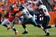 DENVER, CO - SEPTEMBER 29: Running back Ronnie Hillman #21 of the Denver Broncos stiff-arms Jake Knott #54 of the Philadelphia Eagles as Bradley Fletcher #24 gives chase during the second quarter at Sports Authority Field Field at Mile High on September