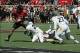 Oct 13, 2012; Lubbock, TX, USA; Texas Tech Red Raiders tight end Jace Amaro (22) is tackled by West Virginia Mountineers safety Darwin Cook (25) in the second half at Jones AT&T Stadium. Mandatory Credit: Michael C. Johnson-USA TODAY Sports