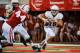 LINCOLN, NE - AUGUST 31: Quarterback Brett Smith #16 of the Wyoming Cowboys scrambles away from defensive end Randy Gregory #44 of the Nebraska Cornhuskers during their game at Memorial Stadium on August 31, 2013 in Lincoln, Nebraska. Nebraska defeated Wy