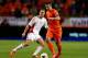 AMSTERDAM, NETHERLANDS - OCTOBER 11: Robin van Persie of Holland in action with Zsolt Korcsmar of Hungary during the FIFA 2014 World Cup Qualifing match between Holland and Hungary at Amsterdam Arena on October 11, 2013 in Amsterdam, Netherlands. (Photo