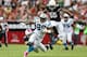 GLENDALE, AZ - OCTOBER 06: Wide receiver Steve Smith #89 of the Carolina Panthers runs with the football after a reception past defensive end John Abraham #55 of the Arizona Cardinals during the NFL game at the University of Phoenix Stadium on October 6,