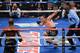 LAS VEGAS, NV - OCTOBER 12: Juan Manuel Marquez tries to keep his balance after being hit by WBO welterweight champion Timothy Bradley Jr. (L) as referee Robert Byrd looks on in the 12th round of their bout at the Thomas & Mack Center on October 12, 2013