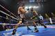 LAS VEGAS, NV - OCTOBER 12: WBO welterweight champion Timothy Bradley Jr. (R) throws a right punch at Juan Manuel Marquez during their bout at the Thomas & Mack Center on October 12, 2013 in Las Vegas, Nevada. (Photo by Jeff Bottari/Getty Images)