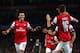 LONDON, ENGLAND - OCTOBER 01: Mesut Oezil #11of Arsenal is congratulated by teammate Aaron Ramsey #16 after scoring the opening goal during UEFA Champions League Group F match between Arsenal FC and SSC Napoli at Emirates Stadium on October 1, 2013 in L
